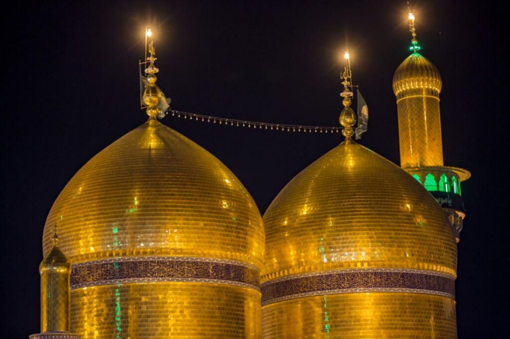 The Imam Al-Kadhim Holy Shrine in Baghdad, Iraq, featuring its magnificent golden domes, minarets, and intricate Islamic architecture.